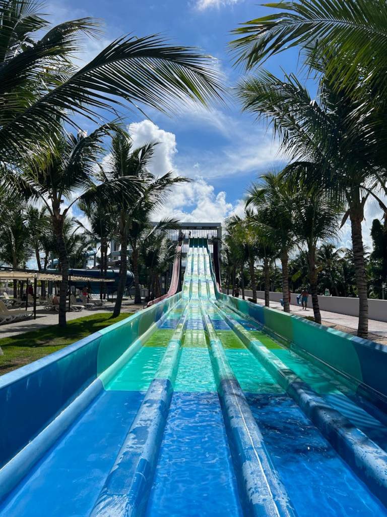 Exciting water slide among palm trees under a bright sky in Punta Cana.