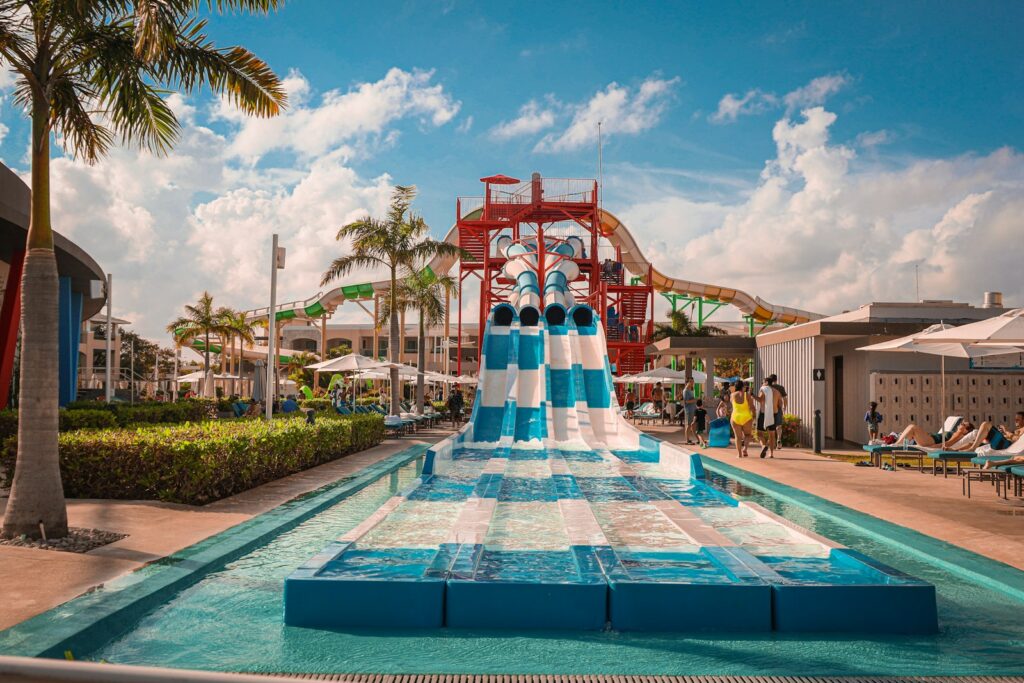 A water park with a water slide and palm trees