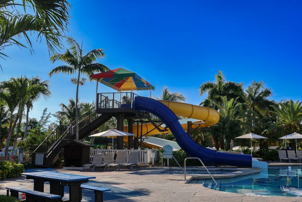 A large water slide next to a swimming pool